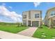 Well-maintained lawn complements a modern two-story home with an attached garage and front door at 2775 Bookmark Dr, Kissimmee, FL 34746