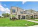 Charming home with lush green lawn and walkway leading to the front entrance and garage at 2775 Bookmark Dr, Kissimmee, FL 34746