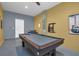 Entertaining game room with a pool table, seating, and colorful wall decor at 2775 Bookmark Dr, Kissimmee, FL 34746