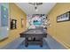 Spacious game room featuring a pool table, ceiling fan and colorful wall art at 2775 Bookmark Dr, Kissimmee, FL 34746