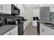 Modern kitchen featuring stainless steel appliances, white cabinets, and a stylish backsplash at 2775 Bookmark Dr, Kissimmee, FL 34746