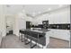 Modern kitchen featuring stainless steel appliances, a large island with seating, and white cabinetry at 2775 Bookmark Dr, Kissimmee, FL 34746