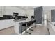 Modern kitchen with stainless steel appliances, a center island with seating, and stylish backsplash at 2775 Bookmark Dr, Kissimmee, FL 34746
