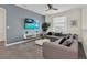 Relaxing living room featuring a large sectional sofa, a flat-screen television, and stylish decor at 2775 Bookmark Dr, Kissimmee, FL 34746