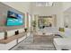 The modern living area boasts a comfortable seating arrangement, a TV, and seamless indoor-outdoor flow at 2775 Bookmark Dr, Kissimmee, FL 34746