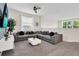 Spacious living room featuring a large sectional sofa, a flat-screen television, and neutral decor at 2775 Bookmark Dr, Kissimmee, FL 34746