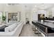 Open concept with large countertop island, modern stools and view to the living room at 2775 Bookmark Dr, Kissimmee, FL 34746