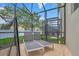 Relaxing screened-in patio with lounge chairs overlooking the landscaped yard at 2775 Bookmark Dr, Kissimmee, FL 34746