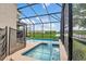 Relaxing screened-in pool area with a spa and views of a lush lawn at 2775 Bookmark Dr, Kissimmee, FL 34746