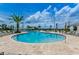 Beautiful community pool with lounge chairs, umbrellas, and palm trees for relaxation and fun in the sun at 2775 Bookmark Dr, Kissimmee, FL 34746