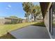 Fenced backyard with green grass and a concrete patio at 2955 Foxcroft Ln, South Daytona, FL 32119