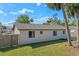 Spacious backyard with well-kept lawn, privacy fence, and mature trees offers ample space for outdoor activities at 2955 Foxcroft Ln, South Daytona, FL 32119
