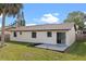Backyard with lush grass and a concrete patio at 2955 Foxcroft Ln, South Daytona, FL 32119