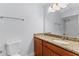Bathroom vanity with granite counters, single sink, modern lighting, and shower tub combo in mirror reflection at 2955 Foxcroft Ln, South Daytona, FL 32119