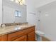 Bright bathroom featuring granite countertop, wood cabinets, and shower at 2955 Foxcroft Ln, South Daytona, FL 32119