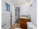 Bathroom featuring granite countertop, wood cabinets, and a window at 2955 Foxcroft Ln, South Daytona, FL 32119