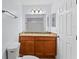 Bathroom with single sink vanity, granite counters, modern lighting, and a shower and tub combo at 2955 Foxcroft Ln, South Daytona, FL 32119