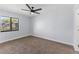 Neutral bedroom with a window and ceiling fan, newly carpeted at 2955 Foxcroft Ln, South Daytona, FL 32119
