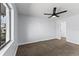 Carpeted bedroom with ceiling fan and natural light at 2955 Foxcroft Ln, South Daytona, FL 32119