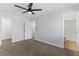 Bedroom with ceiling fan, multiple entry doors, and closet at 2955 Foxcroft Ln, South Daytona, FL 32119