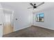 Bedroom showcasing natural light and a ceiling fan with multiple doors at 2955 Foxcroft Ln, South Daytona, FL 32119
