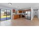Contemporary kitchen featuring stainless steel appliances, granite countertops, and wood cabinets with a sliding glass door to patio at 2955 Foxcroft Ln, South Daytona, FL 32119