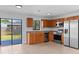 Updated kitchen with stainless steel appliances, granite countertops, and wood cabinetry with a view of the backyard at 2955 Foxcroft Ln, South Daytona, FL 32119