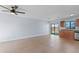Spacious living room featuring tile flooring, a ceiling fan, and a sliding glass door to the backyard at 2955 Foxcroft Ln, South Daytona, FL 32119