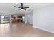 Open-concept living space featuring tile flooring, ceiling fan, and updated kitchen with stainless steel appliances at 2955 Foxcroft Ln, South Daytona, FL 32119