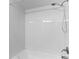 Shower with a white shower head and white tiled walls at 2955 Foxcroft Ln, South Daytona, FL 32119