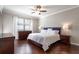 Cozy bedroom features dark hardwood floors and a ceiling fan at 2956 Falconhill Dr, Apopka, FL 32712
