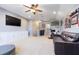 Spacious bonus room with plush carpeting, ceiling fan, media center, and comfortable seating at 2956 Falconhill Dr, Apopka, FL 32712