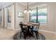 Bright dining area features a round table, stylish chandelier, and a view of the landscaped yard at 2956 Falconhill Dr, Apopka, FL 32712