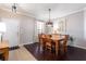 Dining room with dark wood floors, natural light, and stylish light fixture at 2956 Falconhill Dr, Apopka, FL 32712