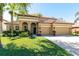 Charming home with a terracotta roof, arched entry, manicured lawn and a two-car garage on a sunny day at 2956 Falconhill Dr, Apopka, FL 32712