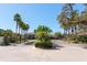 A beautiful gated community entrance with lush landscaping and mature palm trees at 2956 Falconhill Dr, Apopka, FL 32712