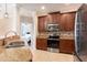 Spacious kitchen with dark cabinets, stainless steel appliances, and decorative backsplash at 2956 Falconhill Dr, Apopka, FL 32712