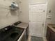 Functional laundry room with modern washer and dryer, shelving, and a neutral color scheme at 2956 Falconhill Dr, Apopka, FL 32712