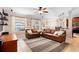 Bright living room with tile floors, ceiling fan, open floor plan with kitchen and dining area at 2956 Falconhill Dr, Apopka, FL 32712
