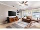 Spacious living room with a ceiling fan, tile flooring, and ample natural light at 2956 Falconhill Dr, Apopka, FL 32712