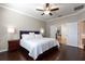 Main bedroom with dark hardwood floors and ensuite bath at 2956 Falconhill Dr, Apopka, FL 32712