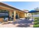 Covered patio with comfortable seating, brick pavers, and an outdoor dining area with a blue umbrella at 2956 Falconhill Dr, Apopka, FL 32712