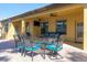 Comfortable outdoor seating area with ceiling fan and mounted TV for entertaining at 2956 Falconhill Dr, Apopka, FL 32712