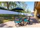 Outdoor patio featuring brick pavers, shade umbrella, dining table and a manicured lawn at 2956 Falconhill Dr, Apopka, FL 32712