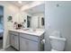 Bathroom featuring a double vanity with grey cabinets and quartz countertop at 3055 Aqua Virgo Loop # 47, Orlando, FL 32837