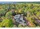 Stunning aerial shot showcases the house nestled amongst trees and offers a sense of seclusion at 322 Harbor Trl, Enterprise, FL 32725