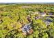 Breathtaking aerial view of the property surrounded by lush greenery, offering privacy and tranquility at 322 Harbor Trl, Enterprise, FL 32725