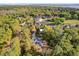 Stunning aerial view of the property showcasing its lush landscaping, pool, and waterfront access at 322 Harbor Trl, Enterprise, FL 32725