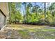 Expansive backyard with lush greenery and a secure fence, perfect for and pets to enjoy at 322 Harbor Trl, Enterprise, FL 32725