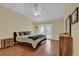Spacious primary bedroom with vaulted ceiling, French doors, and hardwood flooring throughout at 322 Harbor Trl, Enterprise, FL 32725